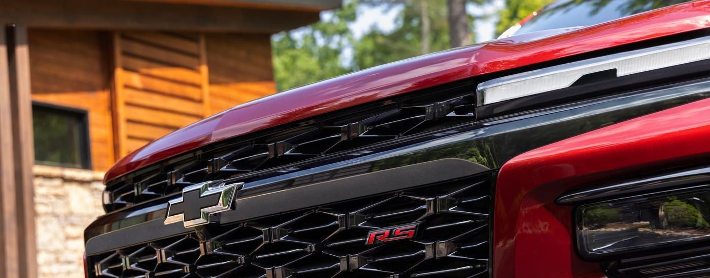 Front grille of a red 2024 Chevy Traverse RS.
