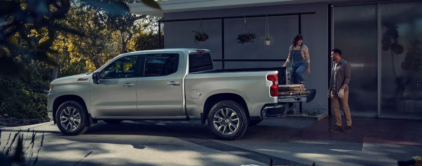 A silver 2025 Chevy Silverado 1500 parked on a driveway.