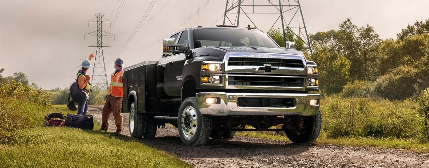 A black 2025 Chevy Silverado 6500 parked near power lines.