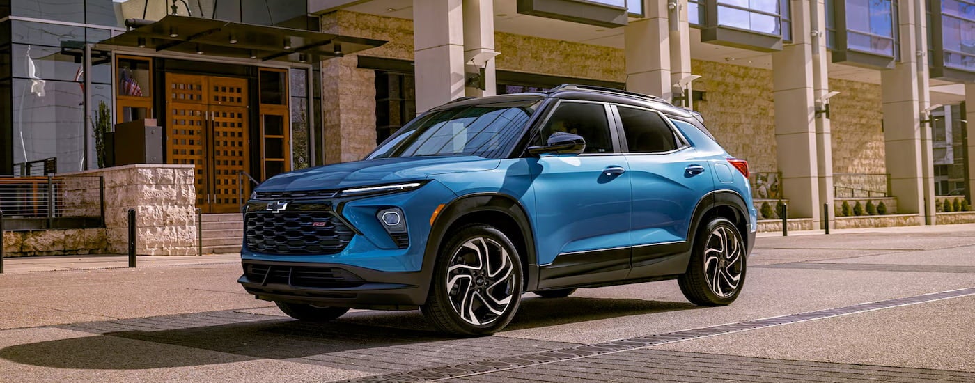Blue 2026 Chevy Trailblazer RS driving down a street.