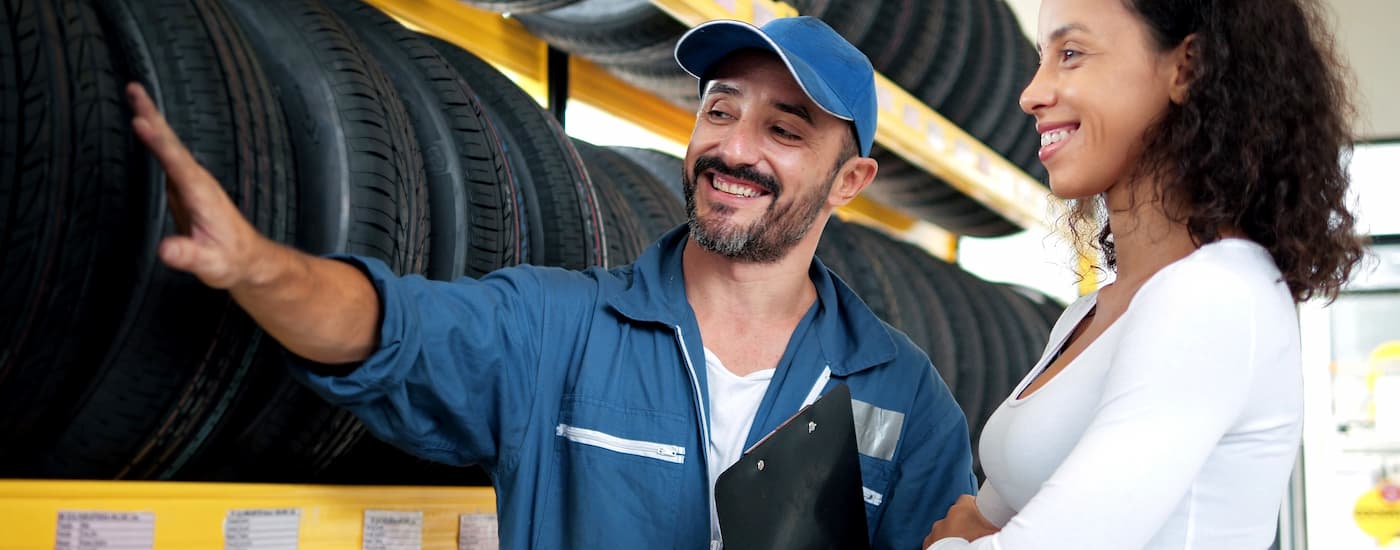 Mechanic helping a customer pick out new tires